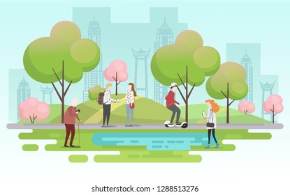 People relaxing in nature in a beautiful urban park, city skyline on the background
