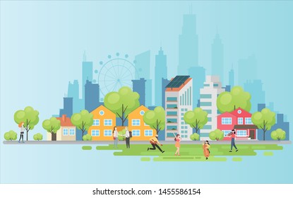 People relaxing in nature in a beautiful urban park, city skyline on the background