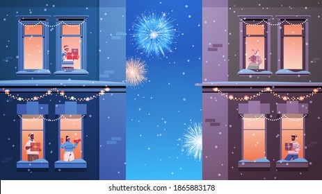 people in santa hats mix race neighbors standing in window frames looking at fireworks in sky new year christmas holidays celebration self isolation concept building house facade horizontal vector