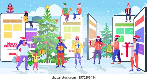 people in santa hats using mobile application mix race men women holding gift boxes online shopping concept christmas new year holidays celebration smartphone screen horizontal full length vector