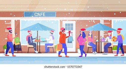 people in santa hats walking outdoor mix race men women holding colorful shopping bags christmas sale winter holidays concept modern city street building exterior horizontal full length vector