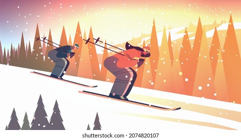 people skiing man woman tourists couple doing activities winter vacation concept sunset snowfall landscape