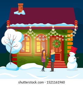 People standing by house decorated for winter holidays. Man and woman by building and snowman with bucket on head. Flat with pine tree glowing inside. New year or Christmas preparation and celebration