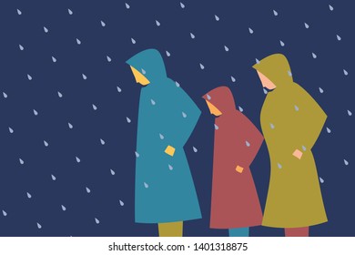 People wearing raincoats walk out in the rain