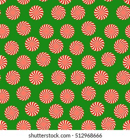 Peppermint candy seamless pattern on green background. Christmas and New Year holiday wrapping paper with mint color sweets. Vector illustration
