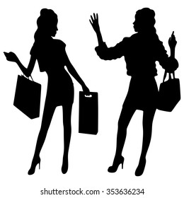 Perfect shopping. Two young pretty stylish girls are holding the shopping bags
