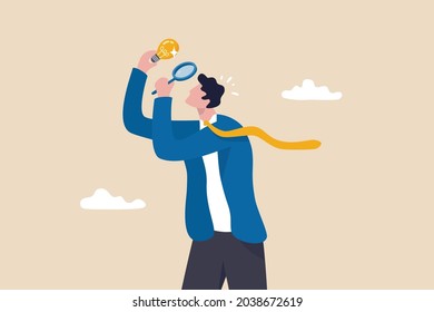 Perfectionist, too much attention to details, high standard goal, focus on perfect result concept, perfectionist businessman with magnifying glass looking at every details of lightbulb idea.