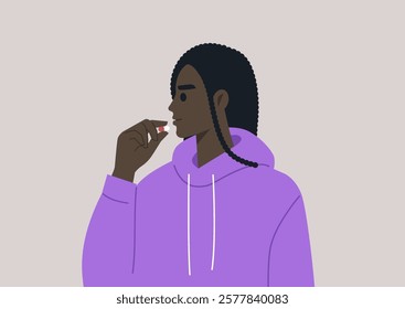 A person in a cozy purple hoodie thoughtfully prepares to take a pill, embracing a moment of self-care and reflection on health and well-being