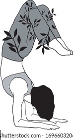 Person doing yoga pose in a leaf patterned pants