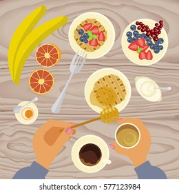 Person is eating breakfast with waffles, fruit, honey and cup of coffe on wooden table. Top view Vector illustration eps 10