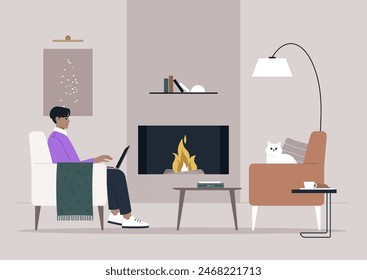 A person enjoys working on their laptop while sitting in a chair by the warm fireplace, with a cat resting nearby on another chair, and a book on the coffee table