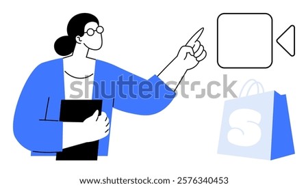 A person with glasses is holding a black object and pointing at a play button symbol. Beside them is a blue shopping bag with a white S. Ideal for online shopping, e-commerce, tutorials, digital