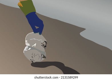 person hand picking up the plastic bottle on the beach