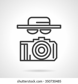 A person with hat, glasses and camera. Secret journalism, paparazzi, spy. Abstract black simple line style vector icon. Single web design element for mobile app or website.