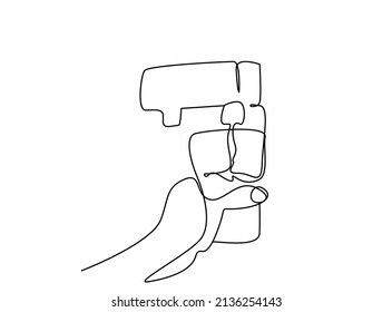 person holding a glass filling water from a water filter machine