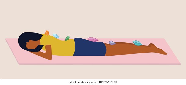 Person laying down with crystals over body