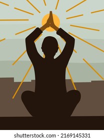 Person meditating in the city and worshiping the sun.
