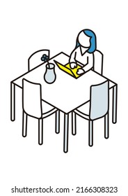 A person operating a laptop at a dining table