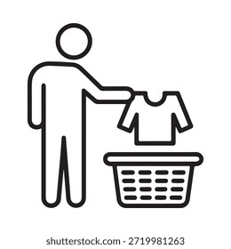 A person placing folded clothes into a wicker laundry basket
