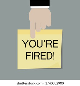 Person pointing “You’re fired” on post it paper.