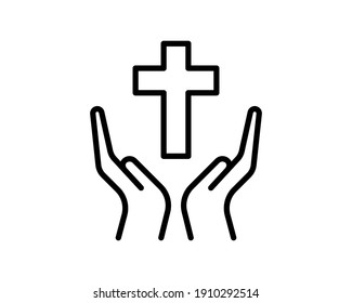 Person praying with cross in hand - concept of a devout christian worshiping Christ.