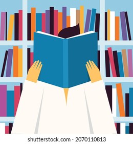 A person reading a book in a library
