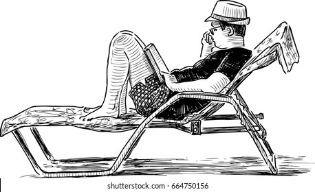 A person reads a book on the beach