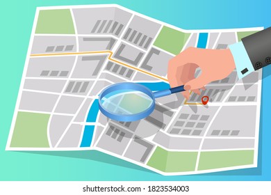 A person studies the map.A man using a magnifying glass examines the map.The concept of navigation positioning.Isometric vector illustration.