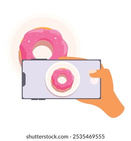 Person is taking a photo of a donut with pink icing on a plate using a smartphone