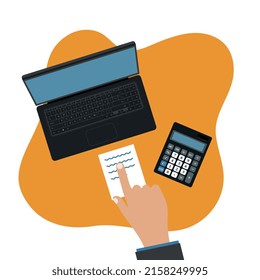 Person using a laptop computer with a notebook and a calculator