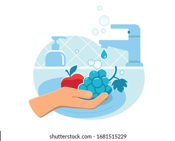 Person washing fresh fruit (apple and grape) in sink carefully with soap from dispenser to prevent coronavirus infection close up. Everyday hygiene essentials. Safety during COVID-19 pandemia.