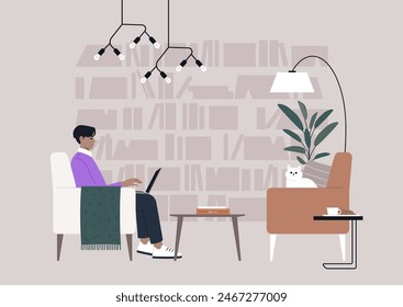 A person is working on a laptop in a cozy library, accompanied by a cat on a nearby chair, with modern lighting and bookshelves in the background