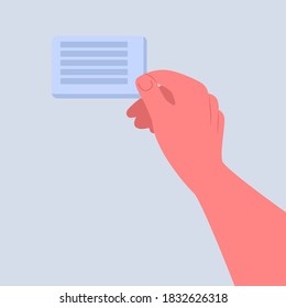 A person's hand is holding a business card