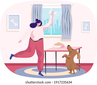 Pet owner happy woman playing with dog at home, funny girl jumping training puppy, gives him bone. Female is having leisure spend time with domestic animal cute doggy, feeding dog food from bowl