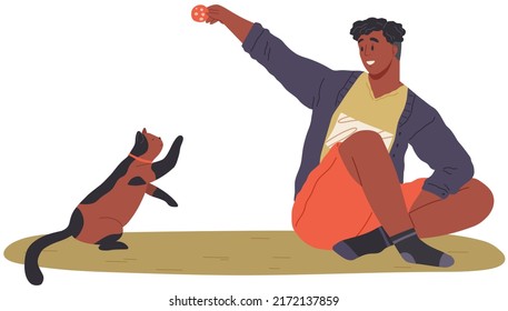 Pet owner plays with cat. Caring for animals, joint pastime with pets concept. Happy guy with kitty, domestic animal companion at home. Male character training kitten. Man spends time with cat