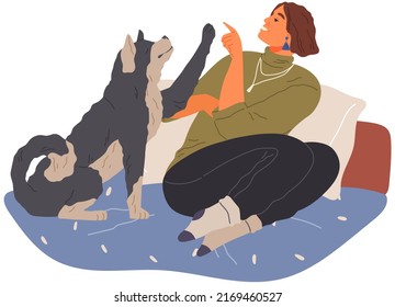 Pet owner plays with dog. Caring for animals, joint pastime with pets concept. Happy lady with puppy, domestic animal companion at home. Dog follows command, gives paw to woman. Girl training doggy