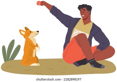 Pet owner plays with dog. Caring for animals, joint pastime with pets concept. Happy guy with puppy, domestic animal companion at home. Male character training doggy. Man spends time with corgi dog