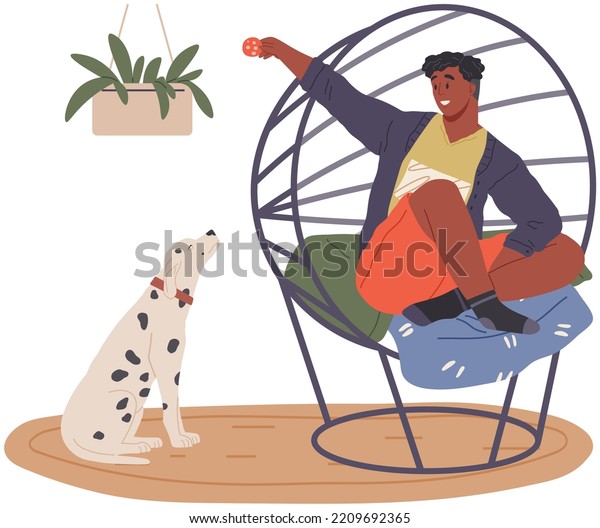 Pet owner plays with dog. Caring for animals,\
joint pastime with pets concept. Happy guy with puppy, domestic\
animal companion at home. Male character training doggy. Man spends\
time with dalmatian