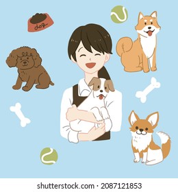A pet store clerk holding a dog.