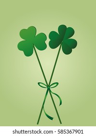 Petals of clover with the image on sticks tied with a ribbon and bow. pozdavitelnaya card for St. Patrick's Day with a blank space for text or advertising. Vector illustration on green background