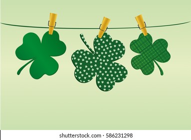 Petals of clover with a picture hanging on a rope with clothespins. St.Patrick 's Day. Vector illustration. Greeting card with empty space for text or advertising. On a green background