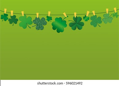 Petals of clover with a picture hanging on a rope with clothespins. St.Patrick 's Day. Vector illustration. Greeting card with empty space for text or advertising. On a green background