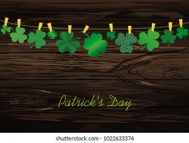 Petals of decorative clover four-leaf hanging on a rope with clothespins. St.Patrick 's Day. Vector illustration. Greeting card with empty space for text or advertising. On a wooden background.