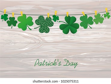 Petals of decorative clover four-leaf hanging on a rope with clothespins. St.Patrick 's Day. Vector illustration. Greeting card with empty space for text or advertising. On a wooden background.