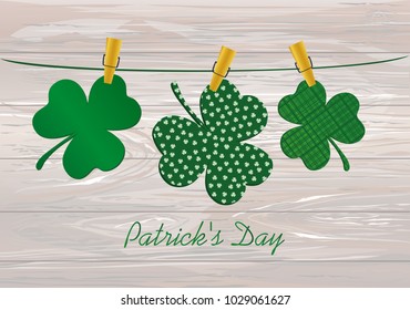 Petals of decorative clover four-leaf hanging on a rope with clothespins. St.Patrick 's Day. Vector illustration. Greeting card with empty space for text or advertising. On a wooden background.