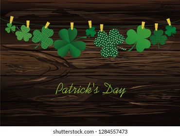 Petals of decorative clover four-leaf hanging on a rope with clothespins. St.Patrick 's Day. Vector illustration. Greeting card with empty space for text or advertising. On a wooden background.