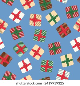 Petit fours frosted as Christmas gifts wrapped up in ribbons of red and green topped with a bow scattered on a blue background creating a vector repeat seamless pattern design.