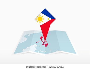 Philippines is depicted on a folded paper map and pinned location marker with flag of Philippines. Folded vector map.