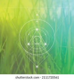 Philosopher stone sacred geometry spiritual new age futuristic illustration with transmutation interlocking circles, triangles and glowing particles in front of blurred natural background.