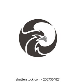 Phoenix or eagle, falcon, hawk head and wing in a circle shape vector icon logo template